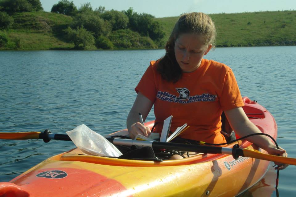 Picture of Marta taking lake samples from a kayak
